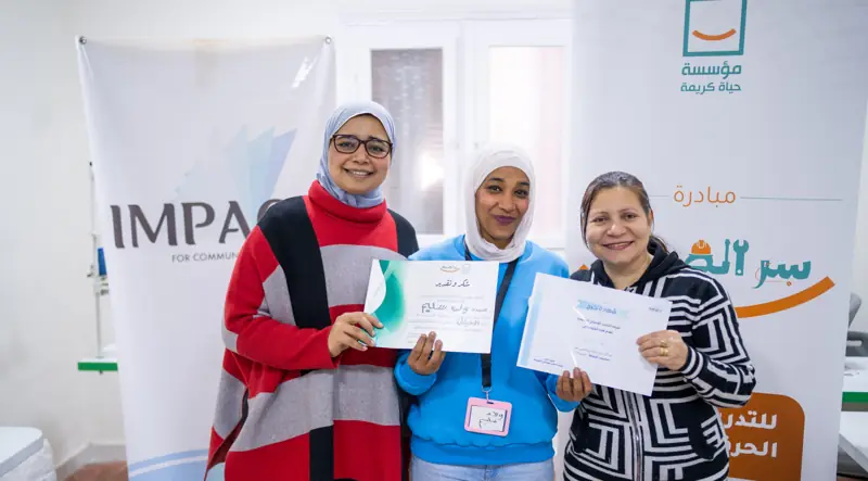 Three graduates with their certificates