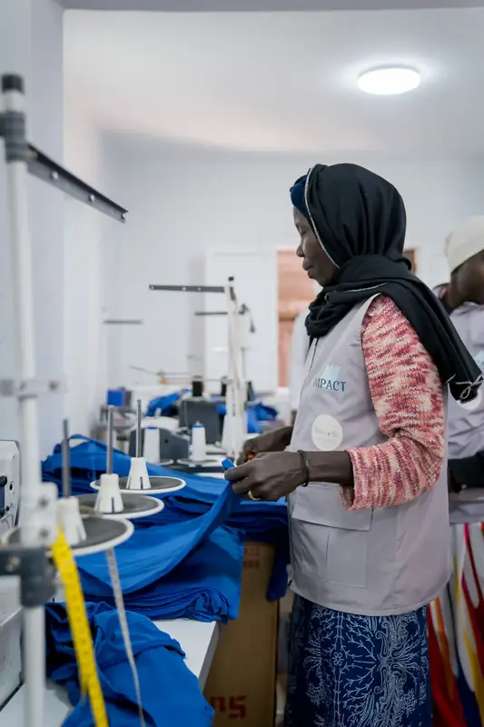 Partners and staff at Impact’s programs and sewing factory