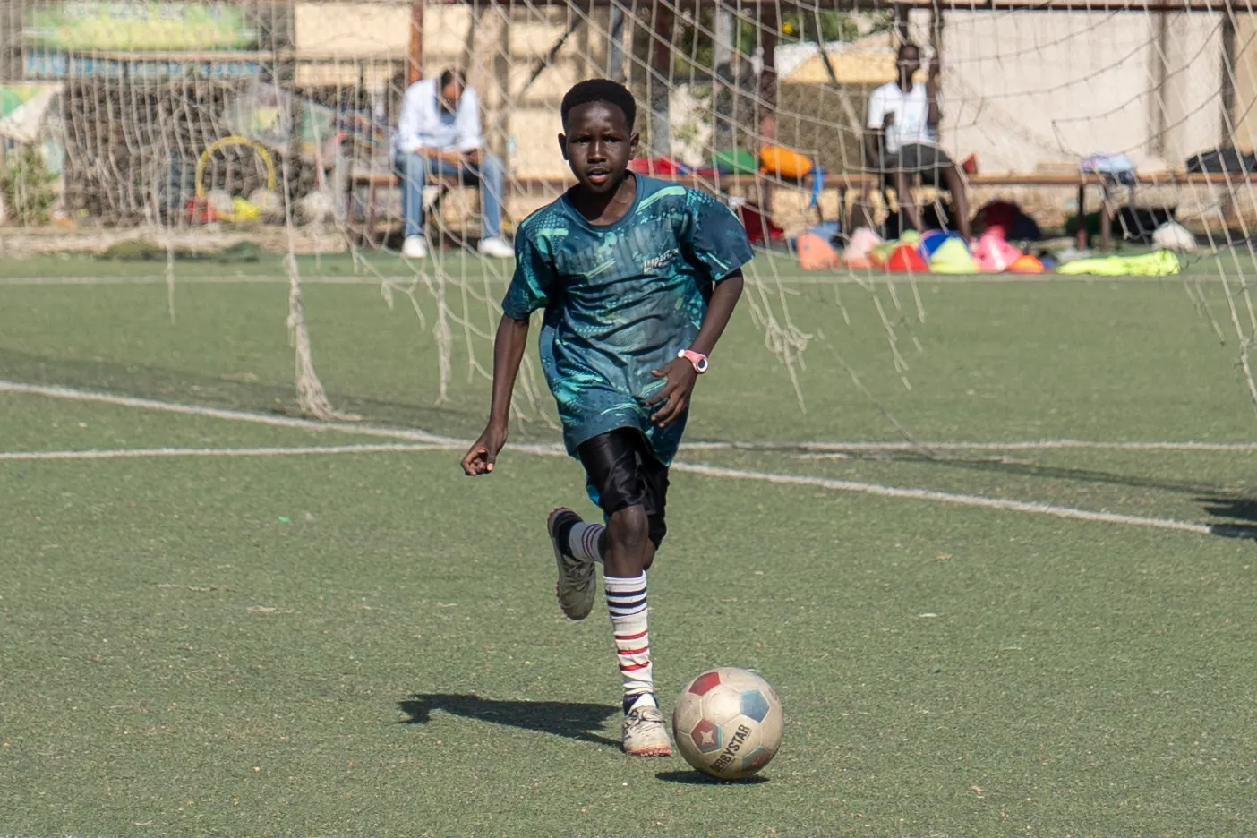 An Impact Sports Academy player dribbles the ball during a match