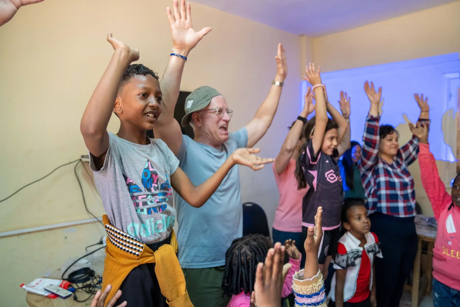 Children cheer at a community day in Aswan