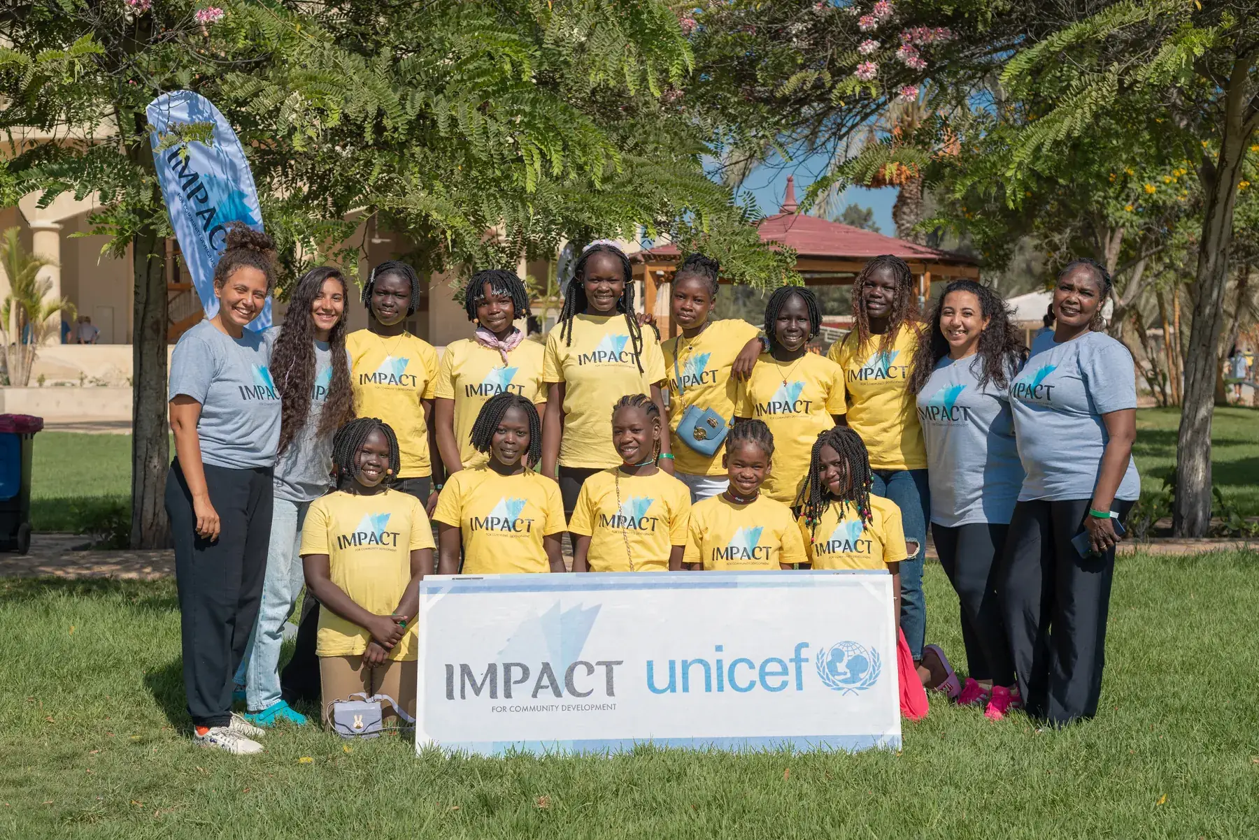 Mazaji camp students and facilitators in front of an Impact and UNICEF banner