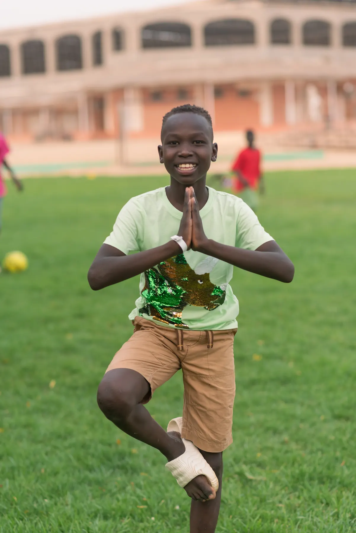 A boy balances in a calming exercise on the grass