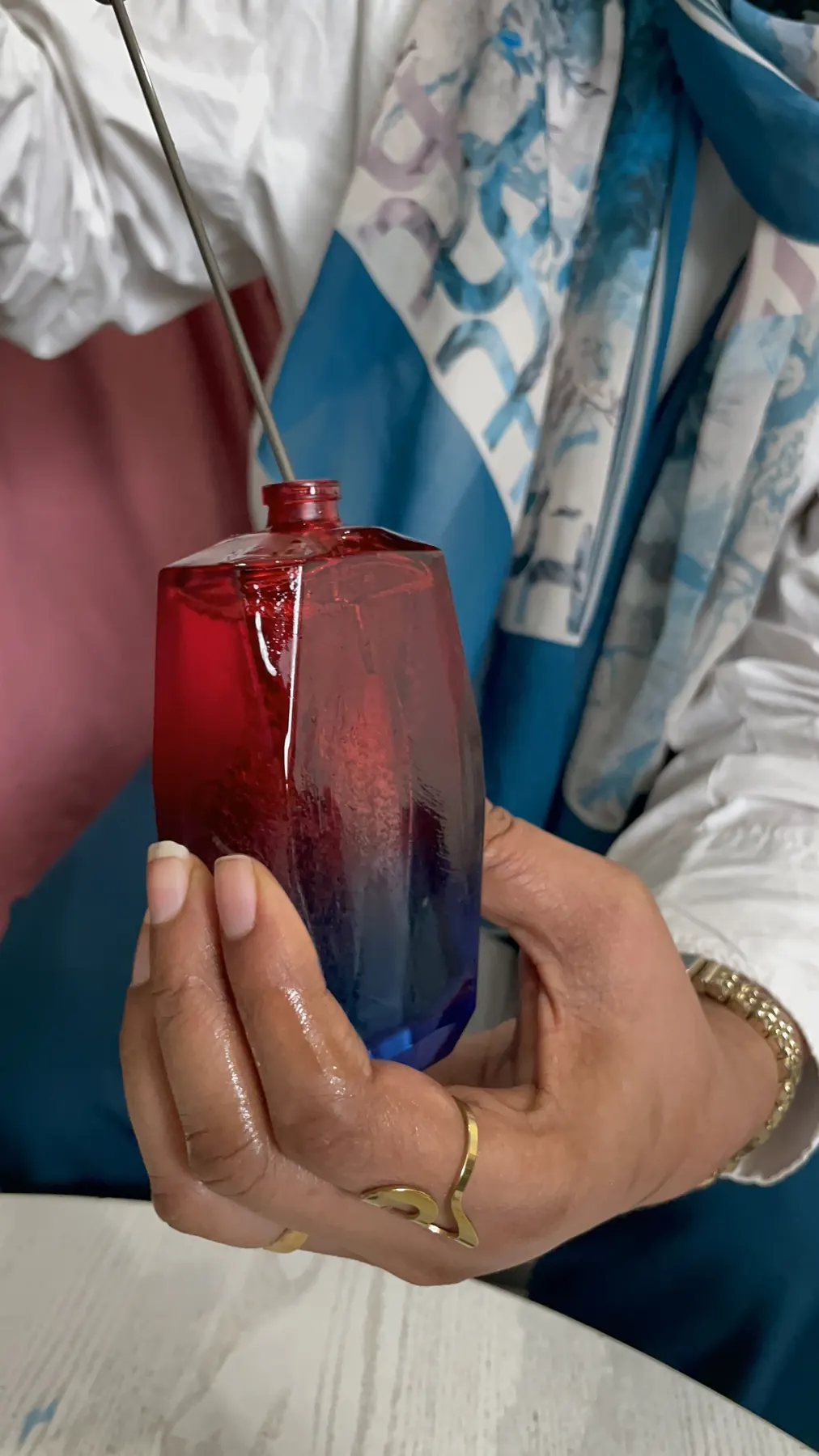 A participant fills a perfume bottle during training